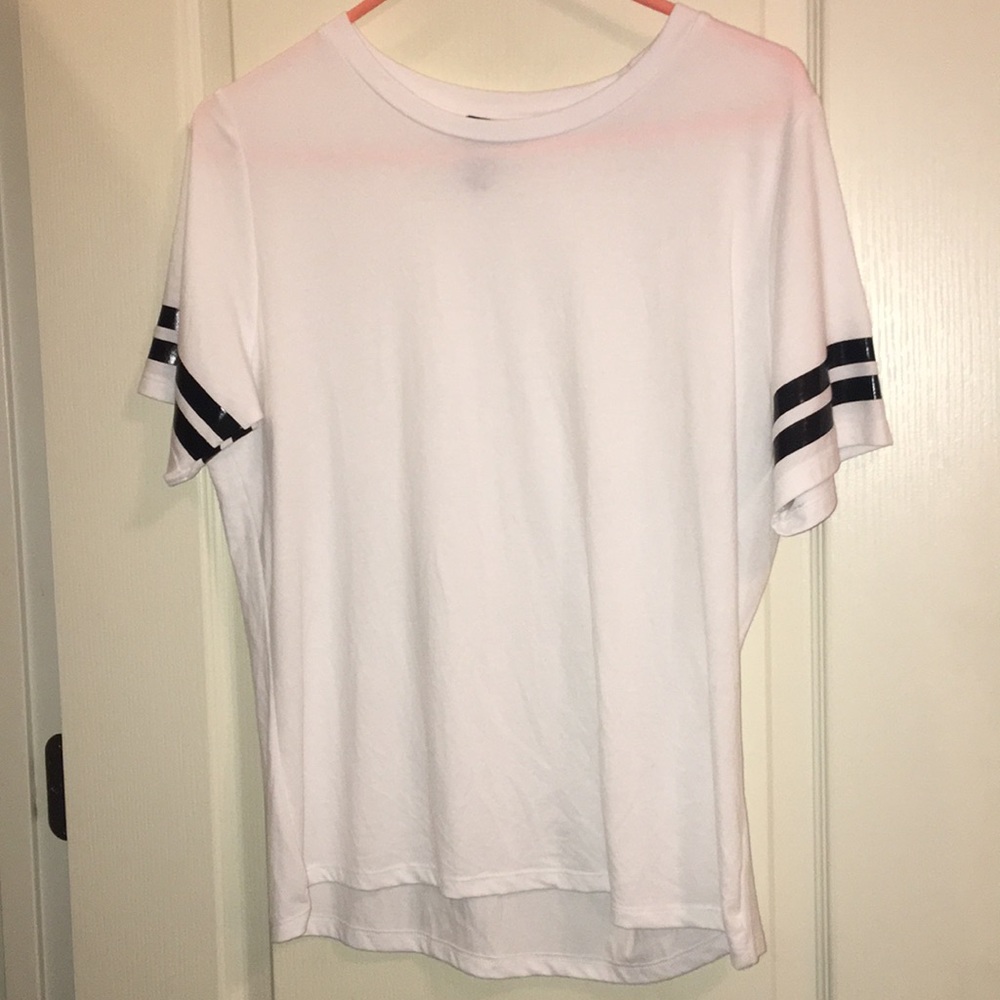 A white t shirt with black stripes on the sleeves